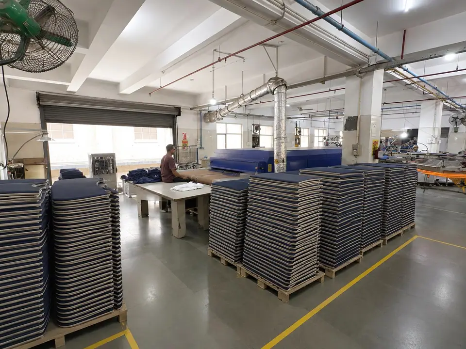 Printed panels stacked for curing beside the production line
